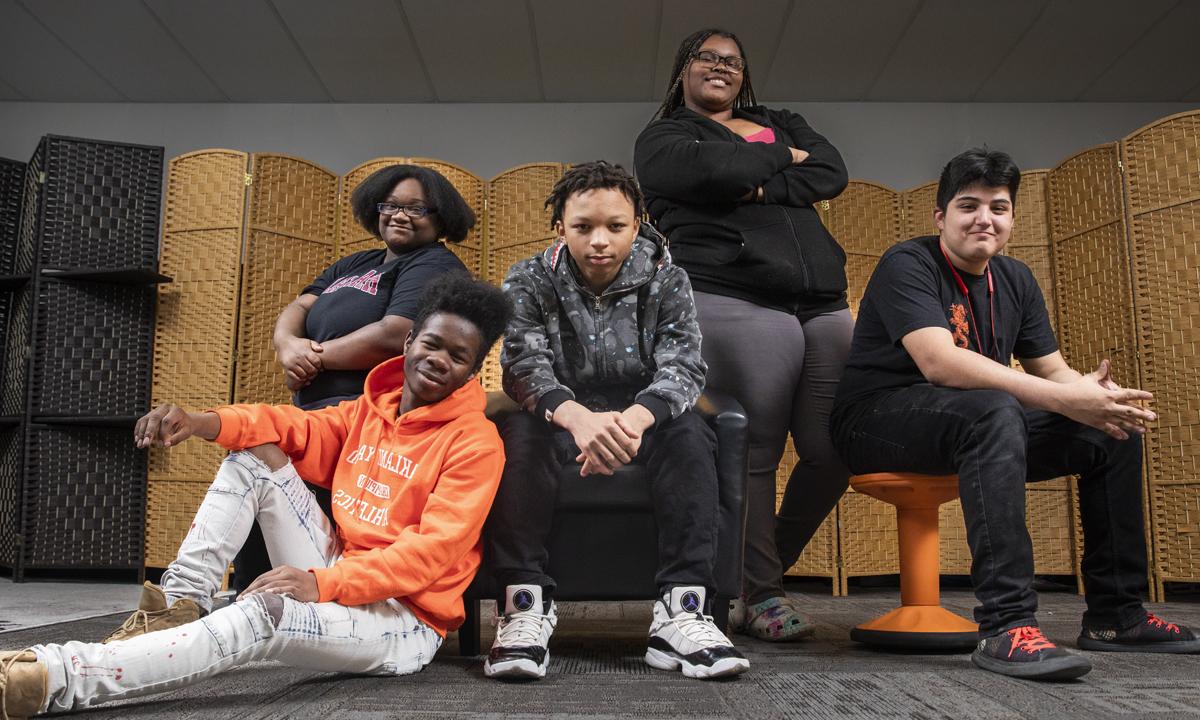 Photo of a group of high school students seated in a classroom looking at the camera